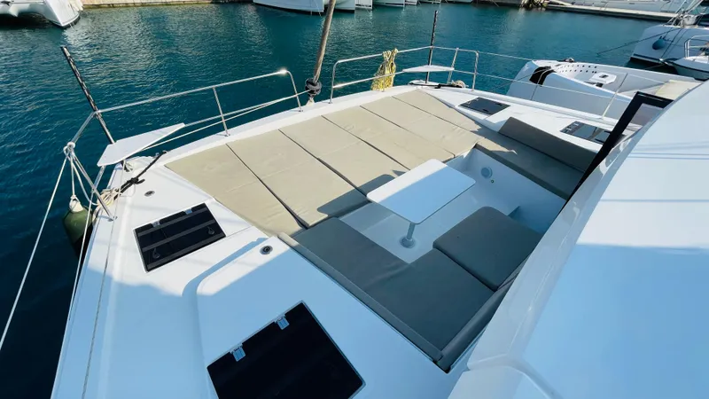  Yacht Photos Pics Luxurious 2022 Bali 4.4 yacht deck with sunbathing area and seating, docked in marina.