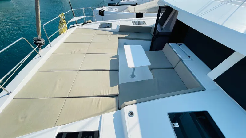  Yacht Photos Pics Luxurious Bali 4.4 yacht deck with cushioned seating and table, 2022 model.