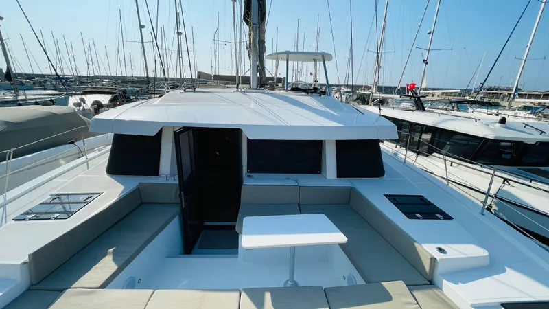  Yacht Photos Pics 2022 Bali 4.4 yacht docked at marina, featuring spacious deck and modern design.