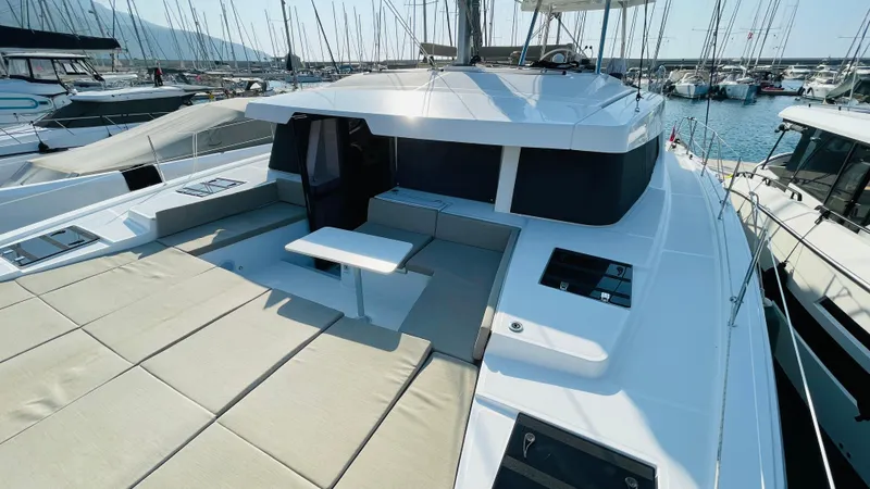  Yacht Photos Pics Modern Bali 4.4 catamaran yacht docked in marina, showcasing spacious deck and sleek design.