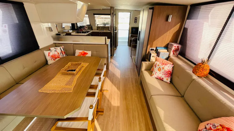  Yacht Photos Pics Luxurious Bali 4.4 yacht interior with elegant seating, dining area, and decorative cushions, 2022 model.