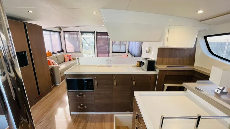  Yacht Photos Pics Luxurious interior of a 2022 Bali 4.4 yacht with modern kitchen and seating area.