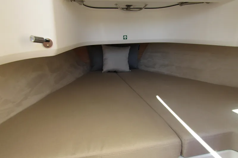  Yacht Photos Pics Cozy interior cabin of 2025 Nimbus Tender 9 with beige cushions and pillow.