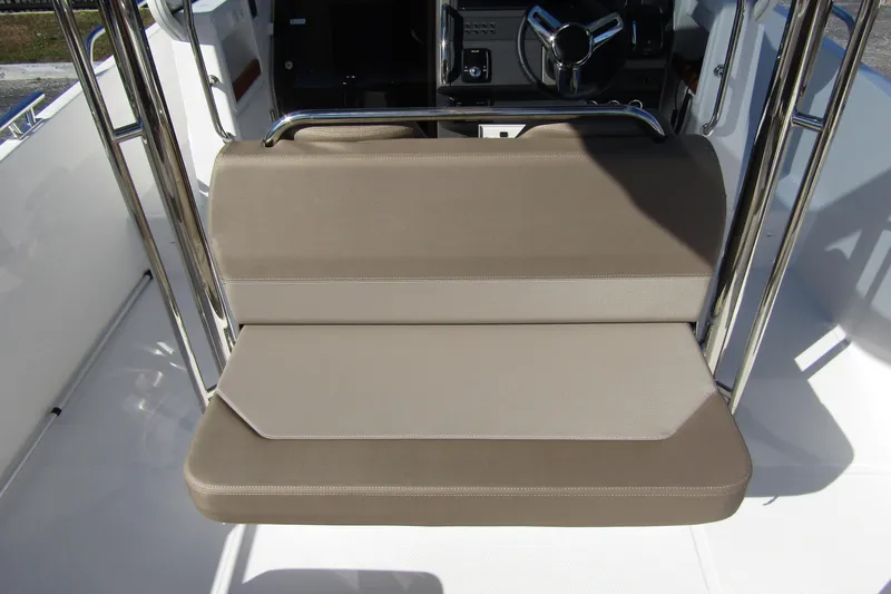  Yacht Photos Pics 2025 Nimbus Tender 9 boat seat with beige upholstery and stainless steel frame.