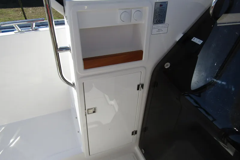  Yacht Photos Pics Interior view of 2025 Nimbus Tender 9 boat, featuring storage compartment and sleek design.