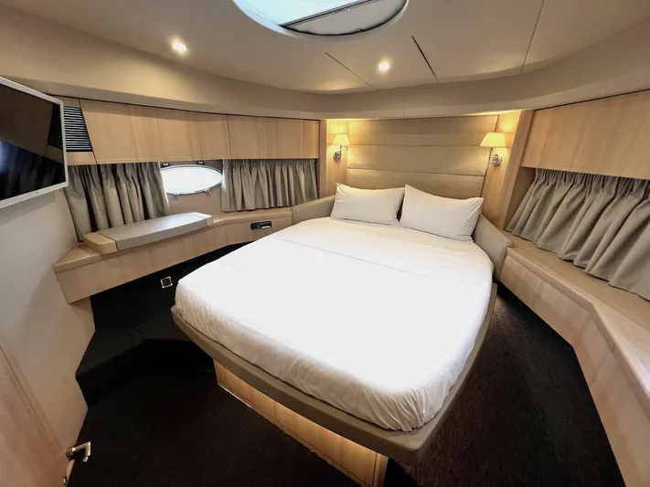  Yacht Photos Pics Luxurious cabin interior of 2006 Princess V70 yacht with elegant bedding and ambient lighting.