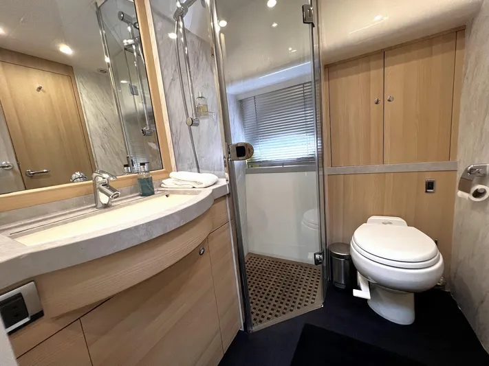  Yacht Photos Pics Luxurious bathroom in a 2006 Princess V70 yacht with modern fixtures and wooden accents.