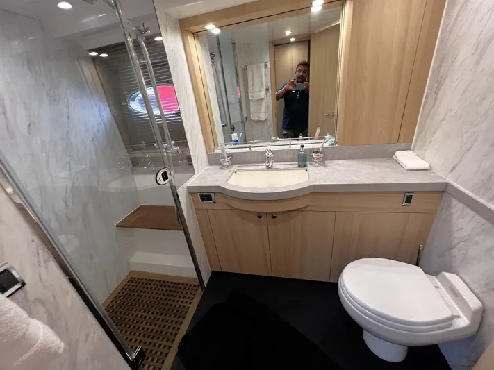  Yacht Photos Pics Luxurious bathroom in a 2006 Princess V70 yacht with modern fixtures and wooden cabinetry.