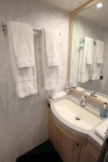  Yacht Photos Pics Luxurious bathroom in 2006 Princess V70 yacht with towels and modern sink.