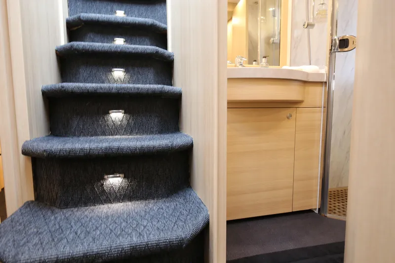  Yacht Photos Pics Carpeted stairs with lights in a 2006 Princess V70 yacht interior.