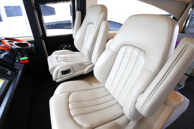  Yacht Photos Pics Luxurious white leather seats in a 2006 Princess V70 yacht cockpit.