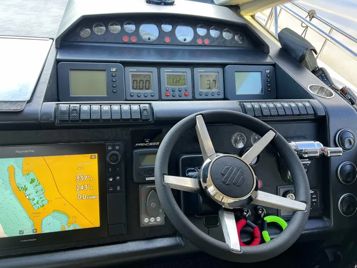  Yacht Photos Pics Steering console of a 2006 Princess V70 yacht with navigation and control instruments.