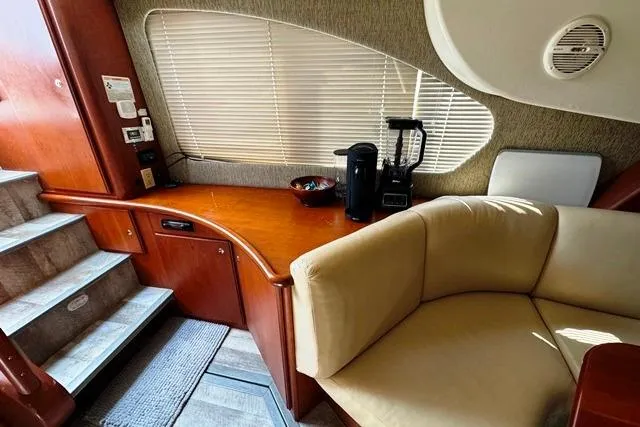  Yacht Photos Pics 2004 Silverton 35 MY Aft Cabin Motoryacht interior with cozy seating and wooden cabinetry.