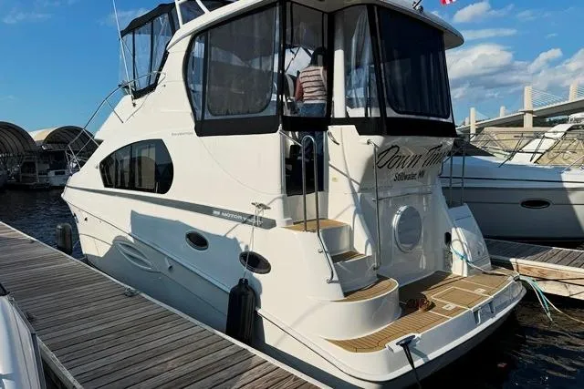  Yacht Photos Pics 2004 Silverton 35 MY Aft Cabin Motoryacht docked at marina under blue sky.