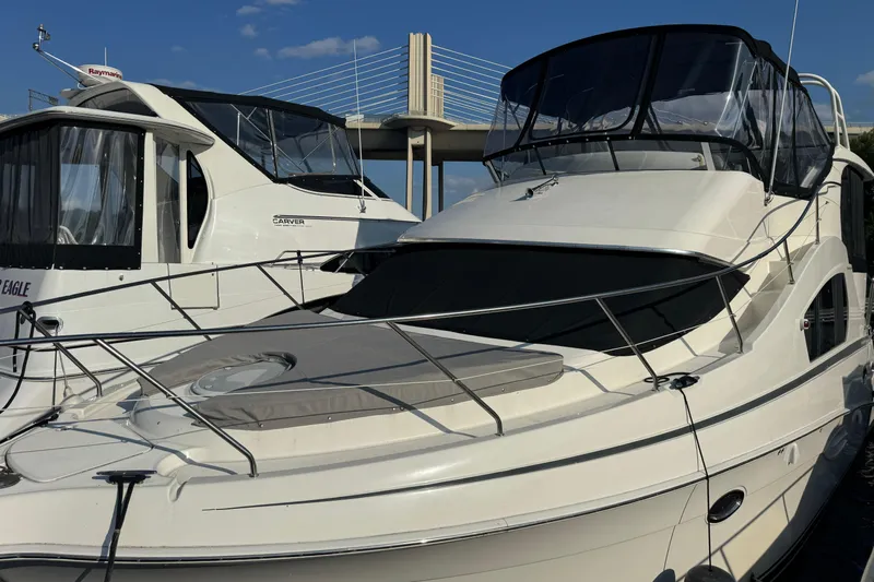  Yacht Photos Pics 2004 Silverton 35 MY Aft Cabin Motoryacht docked beside another yacht.