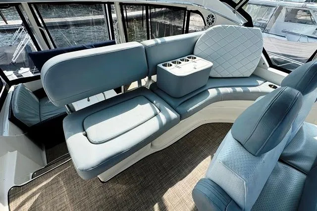  Yacht Photos Pics 2004 Silverton 35 MY Aft Cabin Motoryacht interior with blue seating and cup holders.