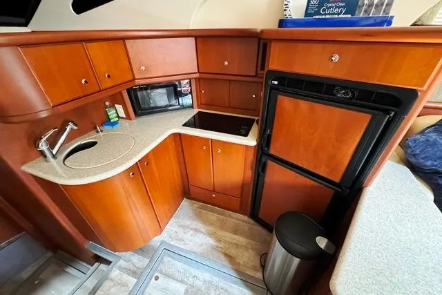  Yacht Photos Pics 2004 Silverton 35 MY Aft Cabin Motoryacht kitchen with wood cabinetry and modern appliances.
