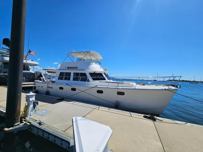 Audrey Louisa Yacht Photos Pics 2012 Maine Cat Power Cat 47 docked at marina under clear blue sky.