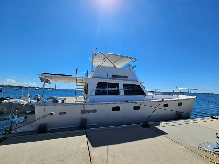 Audrey Louisa Yacht Photos Pics 2012 Maine Cat Power Cat 47 docked at marina under clear blue sky.