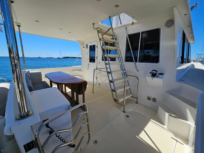Audrey Louisa Yacht Photos Pics 2012 Maine Cat Power Cat 47 yacht interior with seating and table, docked by the sea.