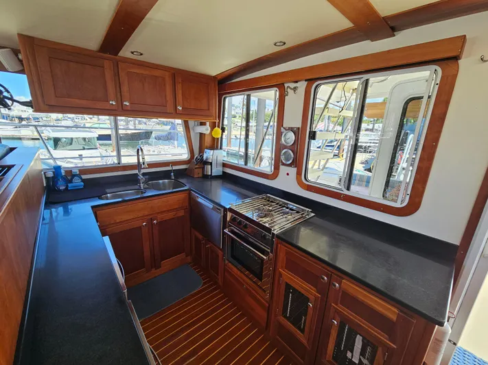 Audrey Louisa Yacht Photos Pics 2012 Maine Cat Power Cat 47 kitchen with wooden cabinets and modern appliances.