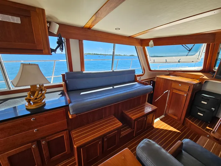 Audrey Louisa Yacht Photos Pics Interior of 2012 Maine Cat Power Cat 47 with wooden furnishings and ocean view.