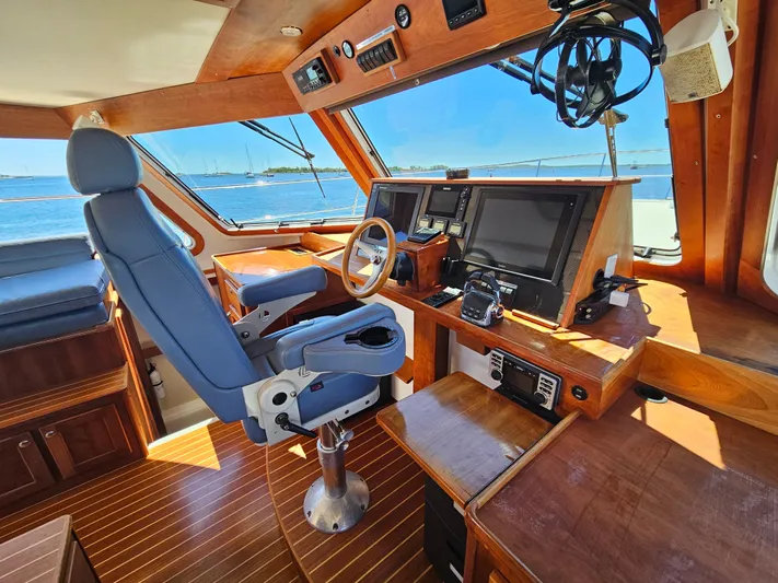 Audrey Louisa Yacht Photos Pics 2012 Maine Cat Power Cat 47 helm station with blue captain's chair and navigation equipment.