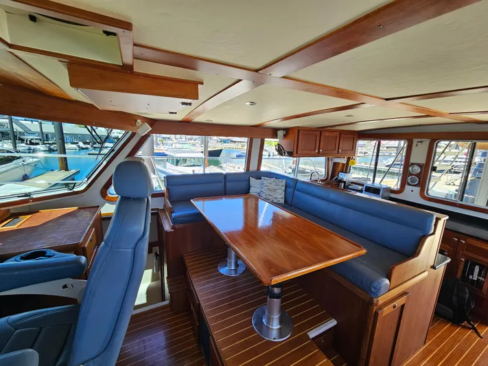Audrey Louisa Yacht Photos Pics Interior of 2012 Maine Cat Power Cat 47 with blue seating and wooden table.