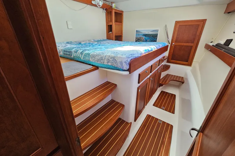 Audrey Louisa Yacht Photos Pics Interior cabin of 2012 Maine Cat Power Cat 47 with wooden steps and bed.
