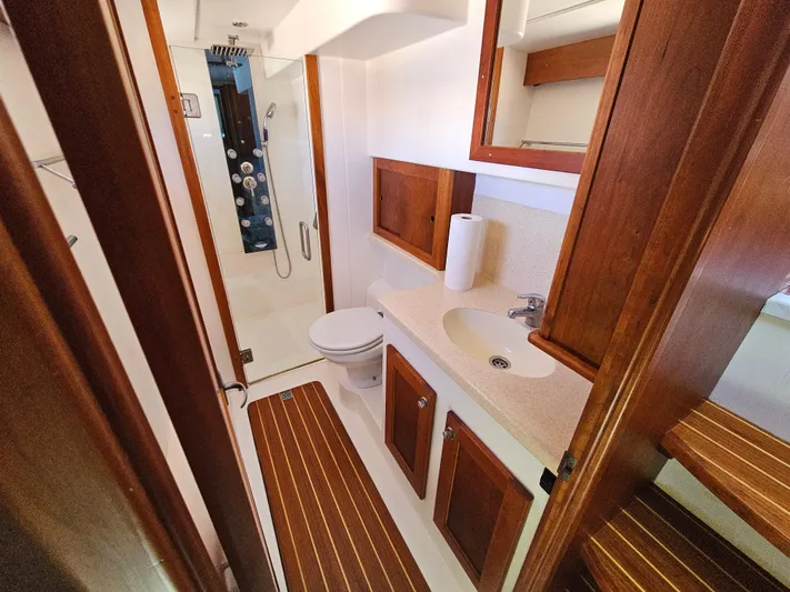 Audrey Louisa Yacht Photos Pics 2012 Maine Cat Power Cat 47 bathroom with wooden cabinets and modern fixtures.