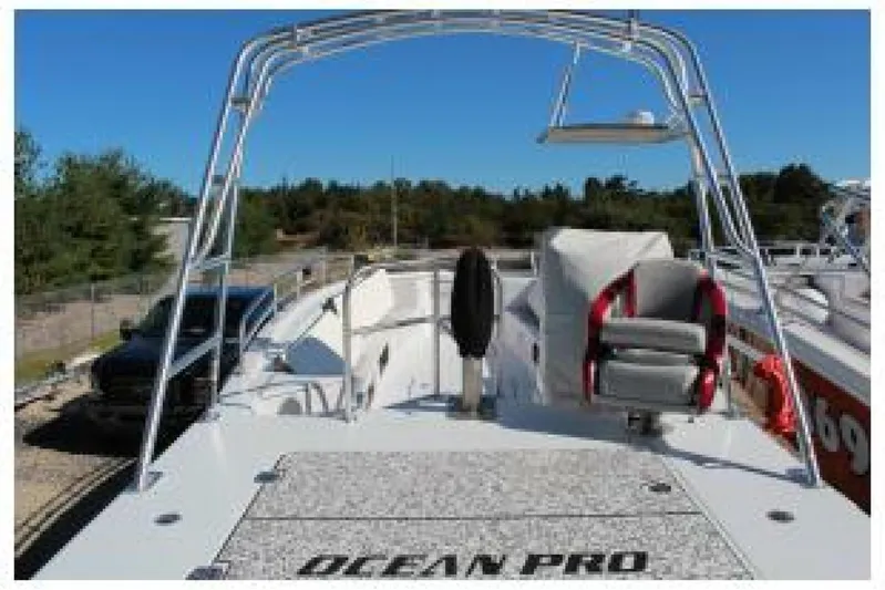  Yacht Photos Pics 2019 OceanPro 35 boat with seating and open deck, parked outdoors.
