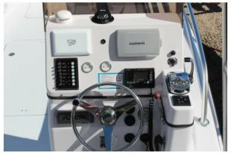  Yacht Photos Pics Control panel of 2019 OceanPro 35 boat with steering wheel and navigation equipment.