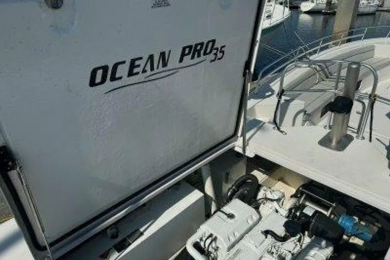  Yacht Photos Pics 2019 OceanPro 35 boat engine compartment at marina, showcasing brand and model details.