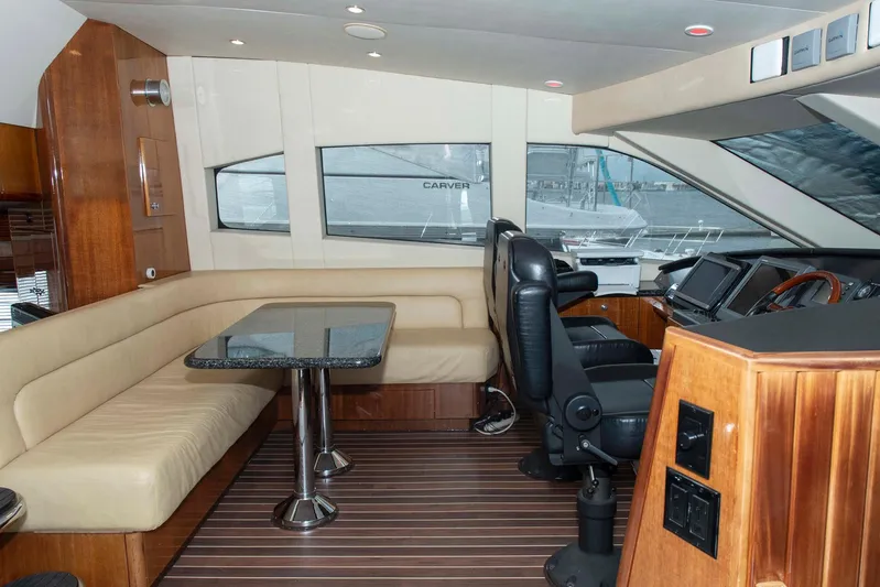 Due South Yacht Photos Pics Luxurious interior of 2002 Hatteras 63 Raised Pilothouse Motor Yacht with seating and helm.