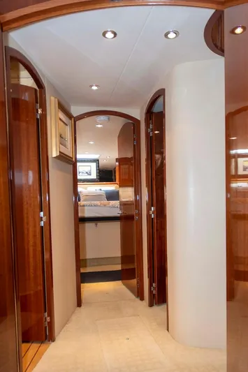 Due South Yacht Photos Pics Interior hallway of 2002 Hatteras 63 Raised Pilothouse Motor Yacht with wooden doors and modern lighting.