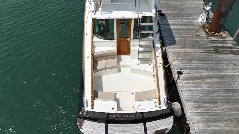 Lady Marion Yacht Photos Pics 2003 Hinckley Talaria 44 FB yacht docked, featuring spacious seating and elegant design.