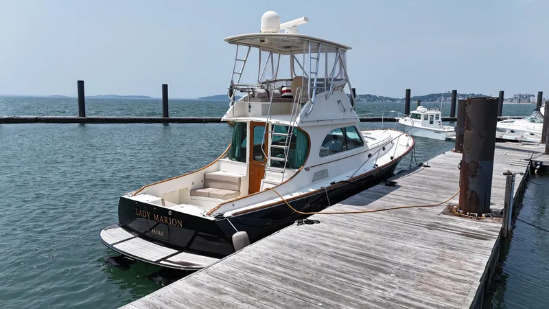 Lady Marion Yacht Photos Pics 2003 Hinckley Talaria 44 FB yacht docked at a marina on a sunny day.
