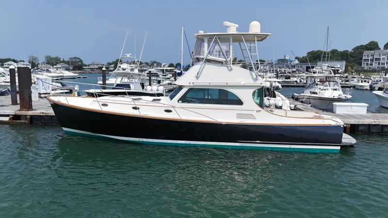 Lady Marion Yacht Photos Pics 2003 Hinckley Talaria 44 FB yacht docked in a marina, surrounded by other boats.