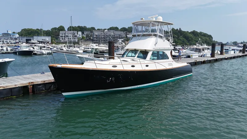Lady Marion Yacht Photos Pics 2003 Hinckley Talaria 44 FB yacht docked at a marina, calm water, clear sky.
