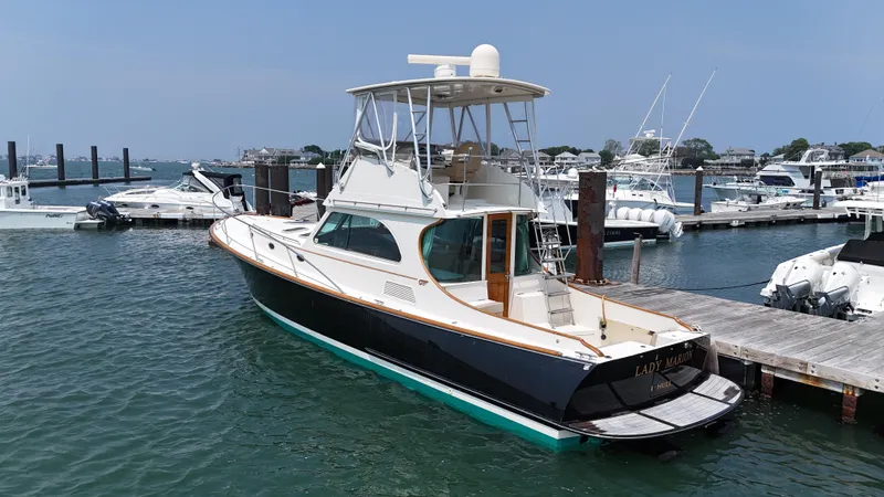 Lady Marion Yacht Photos Pics 2003 Hinckley Talaria 44 FB yacht docked in a marina, surrounded by other boats.