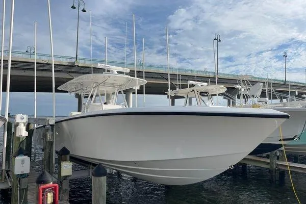 Last Resort Yacht Photos Pics 2013 Bahama 41 Open Fisherman boat docked under a bridge on a sunny day.