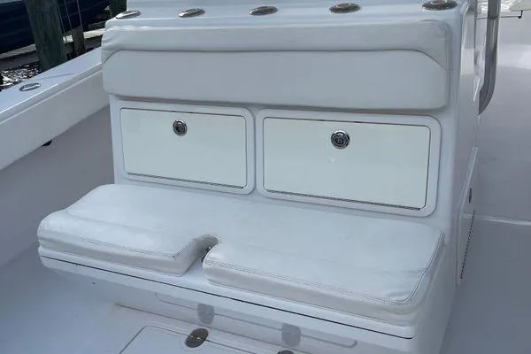 Last Resort Yacht Photos Pics 2013 Bahama 41 Open Fisherman boat seating with storage compartments, featuring white cushioned seats.