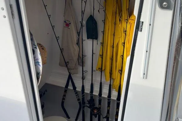 Last Resort Yacht Photos Pics Storage area on a 2013 Bahama 41 Open Fisherman with fishing rods and rain gear.