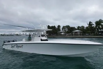 Last Resort Yacht Photos Pics 2013 Bahama 41 Open Fisherman boat on water, overcast sky, palm trees in background.