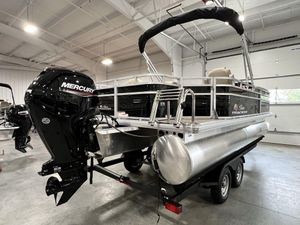 2025 Sun Tracker Sportfish™ 20 DLX pontoon boat with Mercury engine in showroom.