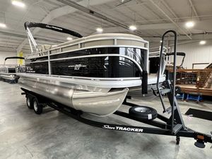 2025 Sun Tracker Sportfish™ 20 DLX pontoon boat on trailer in indoor showroom.