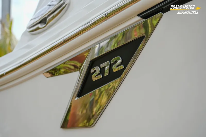  Yacht Photos Pics Close-up of 2026 Blackfin 272 DC boat emblem with chrome detailing.