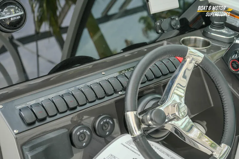  Yacht Photos Pics 2026 Blackfin 272 DC boat dashboard with steering wheel and control panel.