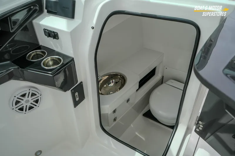  Yacht Photos Pics 2026 Blackfin 272 DC boat interior with toilet and cup holders.