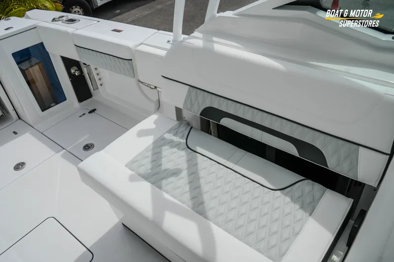  Yacht Photos Pics 2026 Blackfin 272 DC boat interior with white seating and storage compartments.